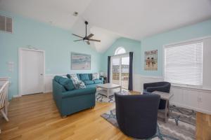 a living room with blue walls and a couch and chairs at 5319 - Day Dreamz in Kill Devil Hills