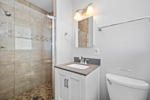 a bathroom with a toilet and a sink and a shower at Paradise East by Emerald Isle Realty in Emerald Isle +33 photos