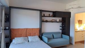 a bedroom with a bed and a blue chair at La terrazza sul Lago Maggiore in Brezzo +39 photos