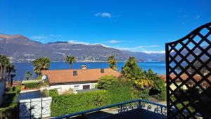 a house with a view of the water and mountains at La terrazza sul Lago Maggiore in Brezzo