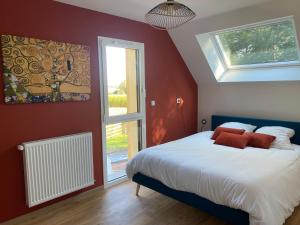 a bedroom with a bed with red walls and a window at Le Cocooning in Asnières +90 photos