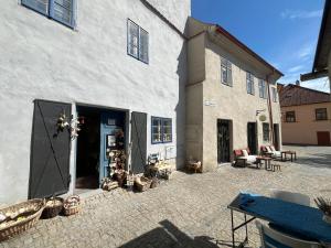 a large white building with a patio in front of it at Apartmany u Synagogy in Třebíč