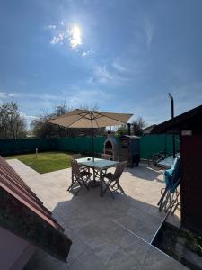 a patio with a table and an umbrella at La casina di Ginevra in Marina di Massa