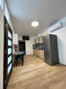 a kitchen with a stainless steel refrigerator and a table at Apartmán Bytča in Bytca