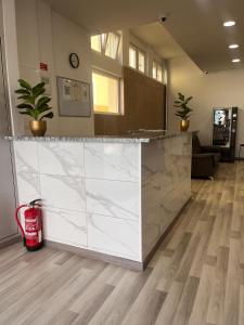an office lobby with a marble counter and a fire extinguisher at The Vault in Portimão