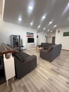 a living room with two couches and a television at The Vault in Portimão