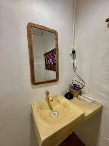a bathroom with a sink and a mirror on the wall at Beach House in Jambiani +57 photos