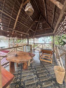 a dining room with a table and a chair at Beach House in Jambiani