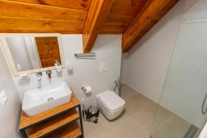 a bathroom with a sink and a toilet at KayakHotel in Ndërlisaj