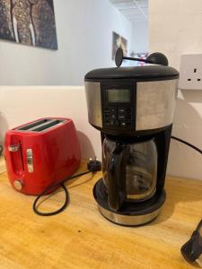 a coffee maker and a toaster sitting on a table at Beach House in Jambiani