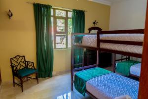 a bedroom with two bunk beds and a window at Villamorametro in Juan Dolio +70 photos
