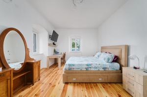 a bedroom with a bed and a vanity and a mirror at Aura Maris Apartment in Kotor
