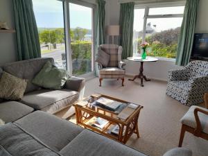 a living room with a couch and a coffee table at Coldstream Cottage in Dale