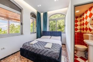 a bedroom with a bed and a sink and a toilet at Shiroka Stays in Shirokë +23 photos