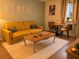 a living room with a couch and a coffee table at Hôtel des Augustins - Boutique Hôtel - Restaurant Gastronomique in Saint-Cyprien