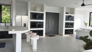 a kitchen with a white counter and a white floor at Villa Blanca only accessible by 4x4 vehicle in El Valle