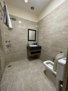 a bathroom with a sink and a toilet at Hotel Oval Hut in Jalandhar