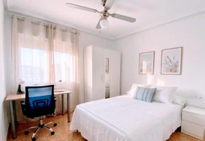 a bedroom with a bed and a desk with a computer at Apartamento EL SOL DEL ZAPILLO in Almería +4 photos