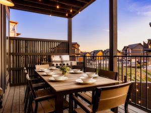 a large wooden table on a deck with a kitchen at Smith Creek Resort - Exclusive Waterpark Included in Sevierville