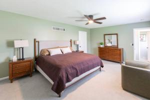 a bedroom with a bed and a ceiling fan at Spacious 4 BR 3 BA with Fenced Yard in Shawnee