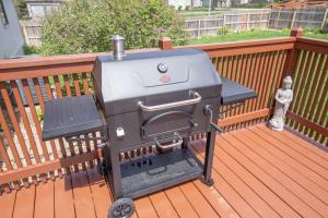 a grill sitting on a deck with a toy at Spacious 4 BR 3 BA with Fenced Yard in Shawnee