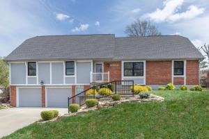 a house with a driveway and grass at Spacious 4 BR 3 BA with Fenced Yard in Shawnee