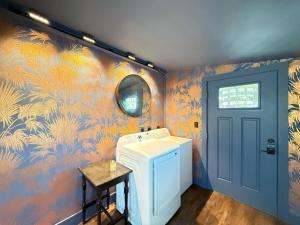 a washer and dryer in a room with a colorful wall at 2 Fun Homes in Hudson +110 photos