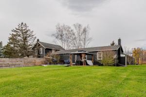 a house with a large yard in front of it at 2 Fun Homes in Hudson