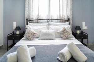a bedroom with a bed with white pillows at Design studio Two in Palekastron