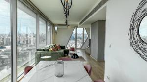 a room with a table and chairs and glass windows at The Cube 10, 3-BR in Sin El Fil in Beirut