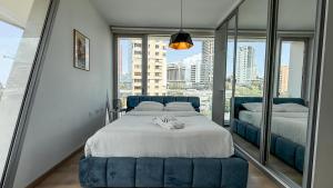 a bedroom with two beds and a large window at The Cube 10, 3-BR in Sin El Fil in Beirut