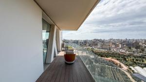 a balcony with a drink on the ledge of a building at The Cube 10, 3-BR in Sin El Fil in Beirut