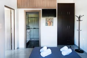 a room with a bed with two white towels on it at Design studio Two in Palekastron +30 photos