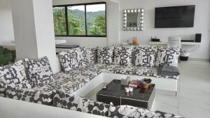 a living room with a black and white couch at Villa Blanca only accessible by 4x4 vehicle in El Valle