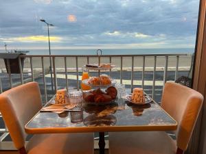 a table with food on it with a view of the beach at Hôtel de la Plage in Narbonne +8 photos