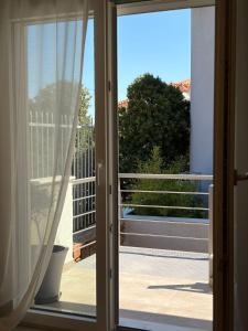 an open door with a view of a balcony at Elea Living Chios in Chios