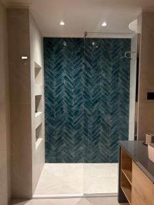 a bathroom with a shower with a glass door at Elea Living Chios in Chios