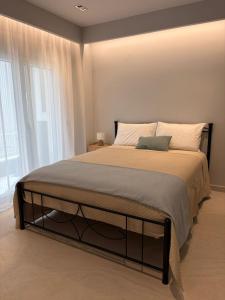 a bedroom with a large bed in front of a window at Elea Living Chios in Chios