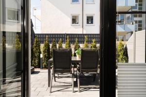 a table and chairs sitting on a patio at Haus Titania Wohnung 2 in Grömitz +32 photos