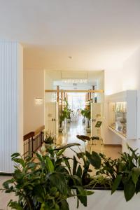 a lobby with potted plants in a building at Grand Hotel Cesare Augusto in Sorrento +93 photos
