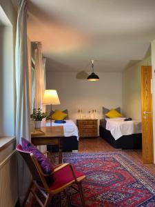 a room with two beds and a table and a chair at Villa Pdorf in Perchtoldsdorf