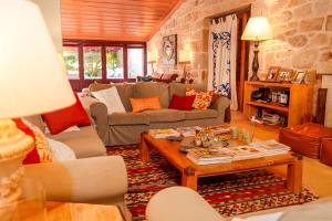 a living room with a couch and a table at Casa Justininho in Ponte de Lima +70 photos