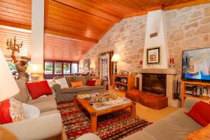 a large living room with a stone wall at Casa Justininho in Ponte de Lima