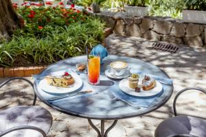 a glass table with food and drinks on it at Grand Hotel Cesare Augusto in Sorrento