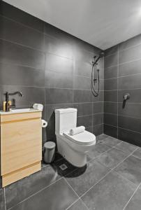 a bathroom with a toilet and a sink and a shower at South Beach Studio - Simple Base, Walk Everywhere in South Fremantle +11 photos