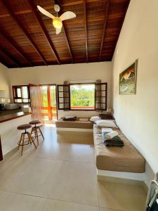 a living room with a couch and a table at Residencial Villa Cris - Jd. São Lourenço/Itaguaré in Bertioga