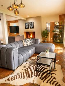 a living room with a couch and a zebra rug at Ekhaya in Hartbeespoort