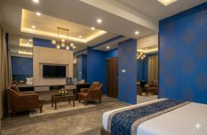 a hotel room with a bed and a desk at Hotel Banana Tree & Banquets 5 Min From Anand Vihar Bus Terminal and Vaishali Metro Station in Ghaziabad