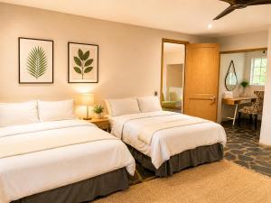 a bedroom with two beds and a desk at Ekhaya in Hartbeespoort +44 photos
