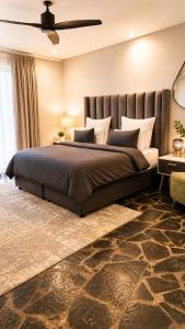 a bedroom with a large bed in a room at Ekhaya in Hartbeespoort